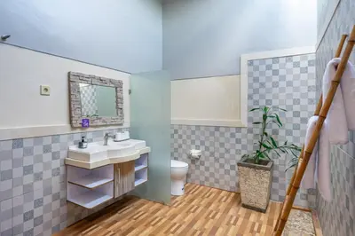 a bathroom with a sink and a toilet at Q LO 1 , Seminyak in Seminyak