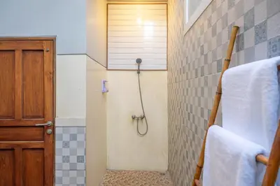 a bathroom with a shower with a shower curtain at Q LO 1 , Seminyak in Seminyak