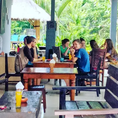 a group of people sitting at a table in a restaurant at Vico hotel in Nusa Dua