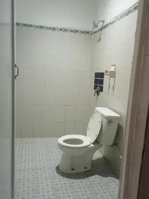 a bathroom with a white toilet in a stall at Vico hotel in Nusa Dua
