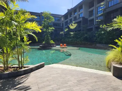 a swimming pool in the middle of a building at de' Asasta Apartment Benoa E216 in Nusa Dua