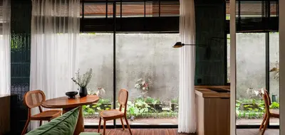 a kitchen with a table and chairs and a window at Aviator Bali in Canggu