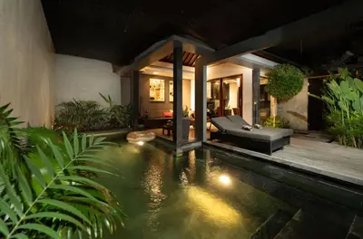 a house with a pool of water with a couch at The Black Pearl - The Best 1br Villa In Seminyak in Seminyak