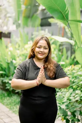 a woman standing with her hands clasped in meditation at The Black Pearl - The Best 1br Villa In Seminyak in Seminyak