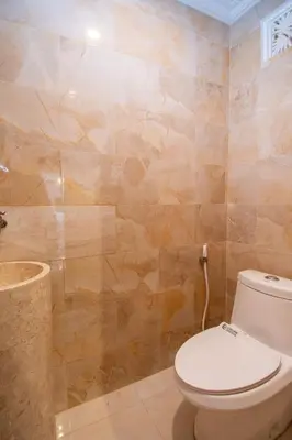 a bathroom with a toilet and a shower at Villa Mayo in Legian