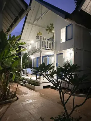 a large white house with a balcony and a patio at Kenzo hut3 mesari in Seminyak