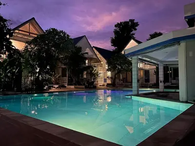 a large swimming pool in front of a house at Kenzo hut3 mesari in Seminyak