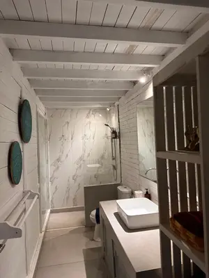 a white bathroom with a sink and a toilet at Kenzo hut3 mesari in Seminyak
