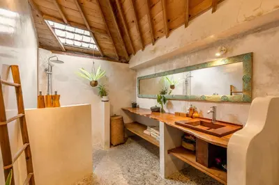 a bathroom with a sink and a mirror at Villa Tago - 5 BR Villa in Umalas in Kerobokan
