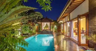 a swimming pool in the middle of a house at ViLLA GREEN MANGO SEMINYAK BALI in Seminyak