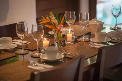 a table with candles and wine glasses on it at ViLLA GREEN MANGO SEMINYAK BALI in Seminyak
