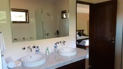 a bathroom with two sinks and a large mirror at ViLLA GREEN MANGO SEMINYAK BALI in Seminyak