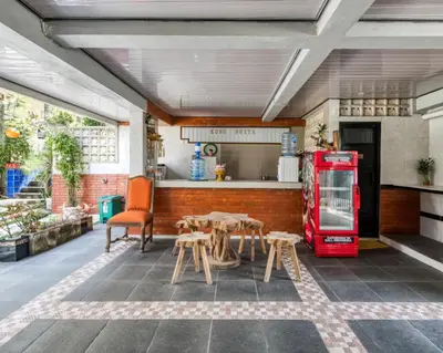 a kitchen with an old red refrigerator and tables at Dhita Kubu in Kerobokan
