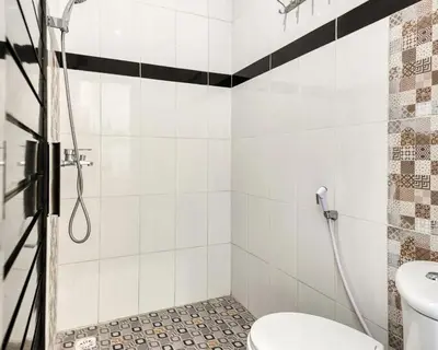 a bathroom with a shower and a toilet at Dhita Kubu in Kerobokan
