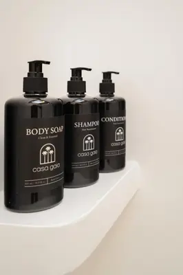 three bottles of body soap sitting on a shelf at Villa Casa Gaia 1 by BaliSuperHost in Umalas