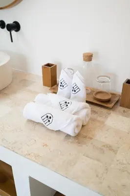 two white towels sitting on a counter in a bathroom at Villa Casa Gaia 1 by BaliSuperHost in Umalas