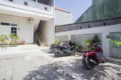 a group of motorcycles parked next to a building at Fun Living Guest House in Seminyak