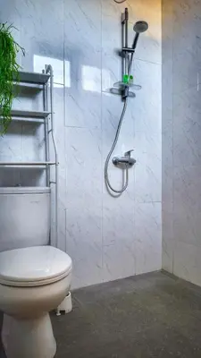 a bathroom with a toilet and a shower at Villa by BALIem in Jimbaran
