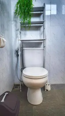 a bathroom with a toilet with a plant above it at Villa by BALIem in Jimbaran