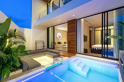 a house with a swimming pool and a bedroom at Alex Villas Complex N5 in Canggu