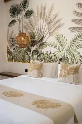 a bedroom with a white bed with plants on the wall at Villa Casa Gaia 5 by BaliSuperHost in Kerobokan