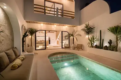 a house with a swimming pool in the middle at Villa Casa Gaia 5 by BaliSuperHost in Kerobokan