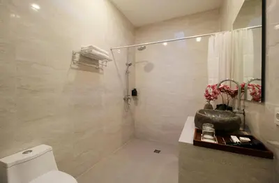 a bathroom with a shower and a sink and a toilet at Bougainvillea Villa Seminyak by Parigata in Seminyak