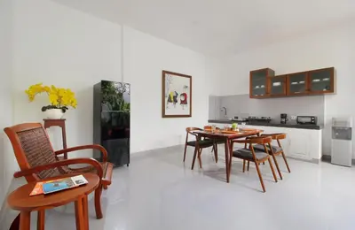 a kitchen with a table and chairs in a room at Bougainvillea Villa Seminyak by Parigata in Seminyak