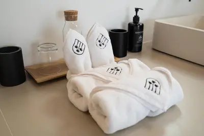 two white towels sitting on a counter next to a sink at Villa Casa Gaia 6 by BaliSuperHost in Kerobokan