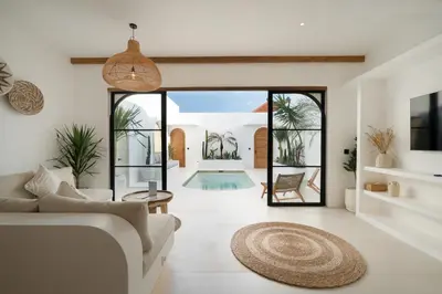 an open living room with a couch and a rug at Villa Casa Gaia 6 by BaliSuperHost in Kerobokan