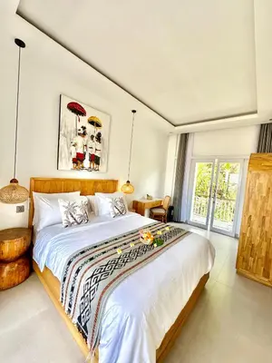 a bedroom with a large bed in a room at Tirta Mumbul Villa in Badung