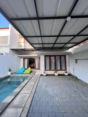 a swimming pool in a building with a ceiling at Louise villa in Jimbaran
