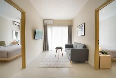 a living room with a couch and a bed at Bali Bustle Sunset Coliving and Coworking Space in Legian
