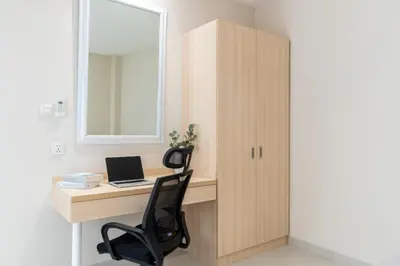 a desk with a chair and a laptop on it at Bali Bustle Sunset Coliving and Coworking Space in Legian