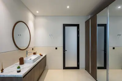 a bathroom with a sink and a mirror at Trendy Modern and Spacious 3Bd Villa in Umalas in Kerobokan