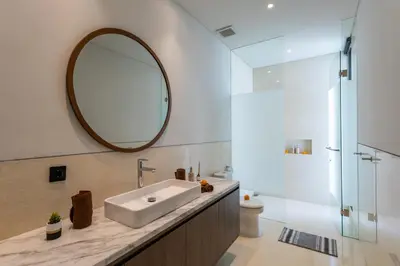 a bathroom with a sink and a mirror at Trendy Modern and Spacious 3Bd Villa in Umalas in Kerobokan