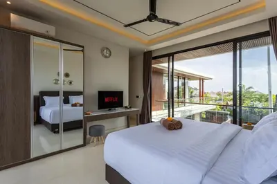 a bedroom with a large bed and a balcony at Trendy Modern and Spacious 3Bd Villa in Umalas in Kerobokan