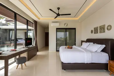 a bedroom with a bed and a desk at Trendy Modern and Spacious 3Bd Villa in Umalas in Kerobokan