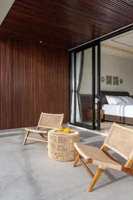 a bedroom with two chairs and a bed and a table at Luxury Chic 3bd Modern Villa in Umalas in Kerobokan