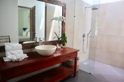 a bathroom with a bowl sink and a shower at The Decks Bali in Legian
