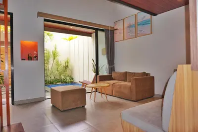 a living room with a couch and a table at The New Moon Umalas in Seminyak