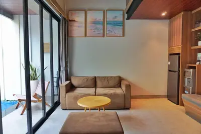a living room with a couch and a table at The New Moon Umalas in Seminyak