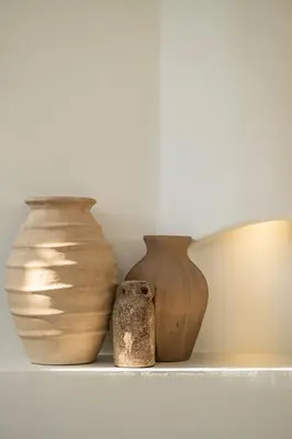 three vases sitting on a shelf next to each other at Casa Siella in Canggu