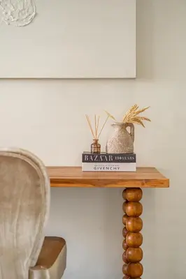 a table with a chair and a book at Casa Siella in Canggu