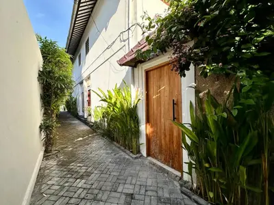 an alley with a wooden door on a building at The Getaway Villa Seminyak Bali in Seminyak
