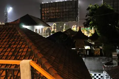 a view from the roof of a building at night at Chillin Kuta Homestay in Kuta