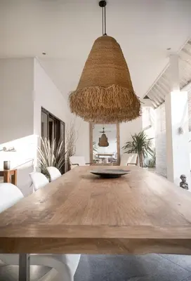 a dining room with a large wooden table with chairs at Tropical 3bdr poolvilla in heart of Seminyak in Seminyak