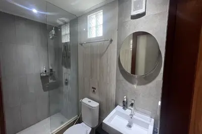 a bathroom with a toilet and a sink and a mirror at Ranala Coliving in Seminyak