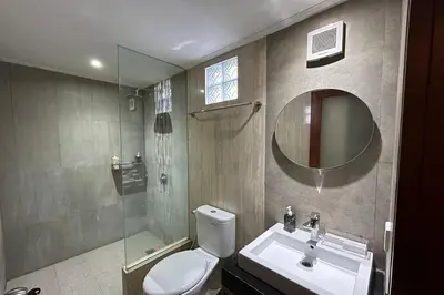 a bathroom with a toilet and a sink and a mirror at Ranala Coliving in Seminyak
