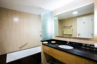 a bathroom with a sink and a mirror at Kuta Reef Apartments in Kuta